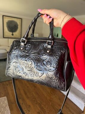 Patricia Nash Black leather Skye Satchel, with crossbody strap.